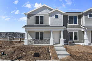 View of front of house featuring a porch and cooling unit