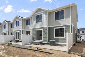 Rear view of property featuring a patio and cooling unit