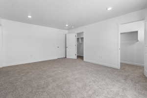 Unfurnished bedroom featuring light colored carpet