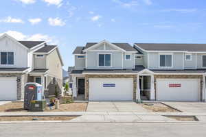 Townhome / multi-family property featuring a garage