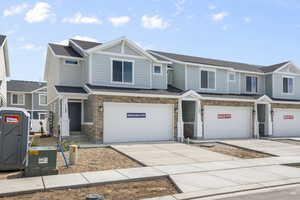 Townhome / multi-family property featuring a garage