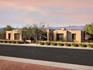 Pueblo-style home featuring a mountain view