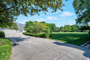 View of home's community featuring a lawn and a mountain view