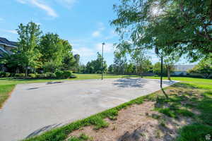 View of basketball court with a lawn