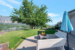 View of patio with a fire pit and a mountain view