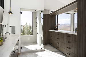 Bathroom with a mountain view, vanity, and an enclosed shower