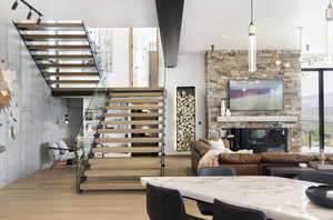 Living room featuring a stone fireplace and light hardwood / wood-style floors