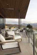 Deck at dusk featuring a mountain view