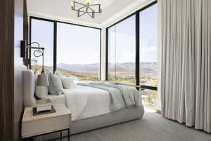 Bedroom featuring a notable chandelier and a mountain view