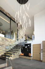 Staircase featuring tile patterned flooring and a high ceiling