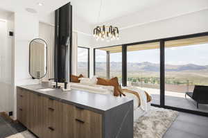 Bathroom featuring a mountain view, vanity, lofted ceiling, and an inviting chandelier