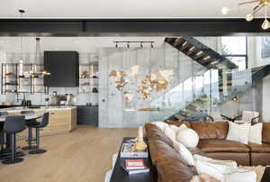 Living room featuring light wood-type flooring and a chandelier