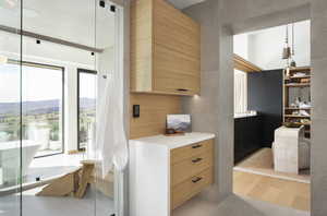 Interior space with a mountain view, light brown cabinetry, and light tile patterned flooring