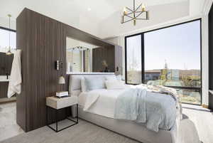 Bedroom with vaulted ceiling and a chandelier