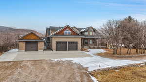 View of front of house featuring a mountain view and a garage