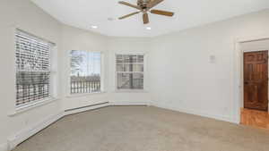 Master Bedroom with light carpet and ceiling fan