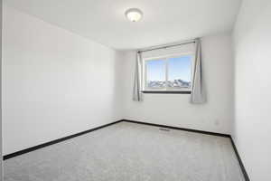 Empty room featuring carpet flooring