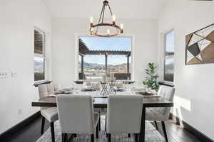 Dining room featuring a mountain view, a chandelier, and dark hardwood / wood-style floors