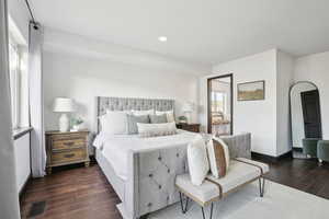 Bedroom with dark hardwood / wood-style floors