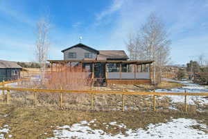 View of snow covered rear of property