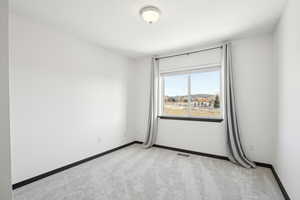 Empty room with light colored carpet