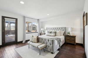 Bedroom with access to outside, multiple windows, and dark wood-type flooring