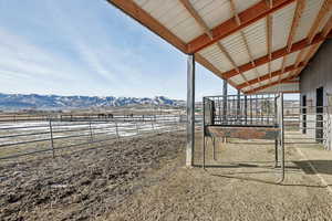 View of yard with a mountain view, a rural view, and an outdoor structure