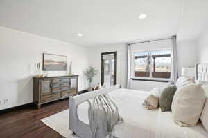 Bedroom with dark hardwood / wood-style flooring