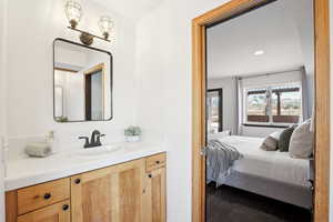 Bathroom with hardwood / wood-style floors and vanity