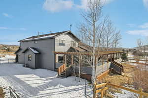 View of snow covered back of property