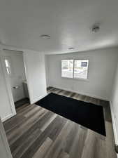 Empty room with dark wood-style floors and baseboards