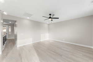 Unfurnished room featuring light wood-type flooring and ceiling fan