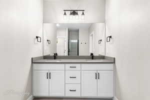 Bathroom featuring vanity and a shower with shower door