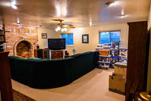 Carpeted living room featuring a textured ceiling