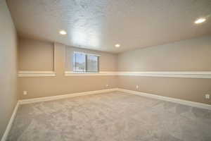 Spare room featuring carpet floors and a textured ceiling