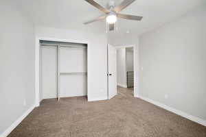 Unfurnished bedroom featuring ceiling fan, carpet floors, and a closet