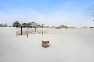 Snowy yard with a fire pit