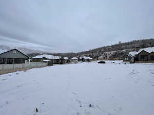 Yard covered in snow with a mountain view