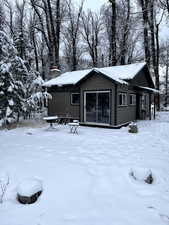 View of snow covered back of property