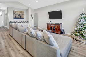 Living room featuring light wood-type flooring and lofted ceiling