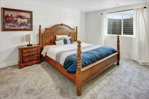 Bedroom with light colored carpet