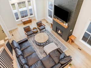 Living room featuring a large fireplace and hardwood / wood-style flooring