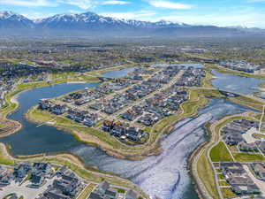 Drone / aerial view featuring a water and mountain view