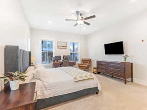 Bedroom with ceiling fan and light colored carpet