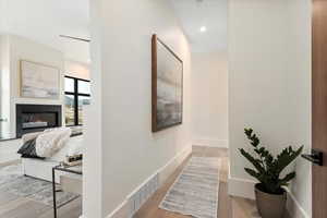 Primary bedroom hall featuring oak flooring