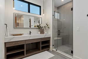 2nd primary spa bath featuring vanity, tile patterned floors, and a shower with shower door