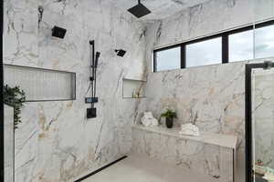 Primary bathroom featuring a tile shower