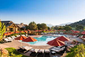 View of pool featuring a mountain view and a patio area