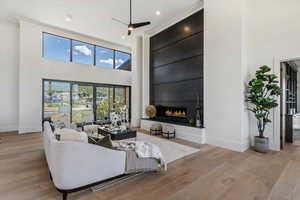 featuring a towering ceiling, a sophisticated steel fireplace,