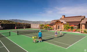 View of sport court with basketball hoop and a mountain view